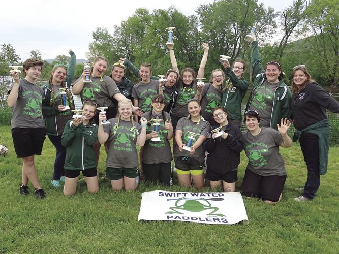 Swift water paddlers with trophy