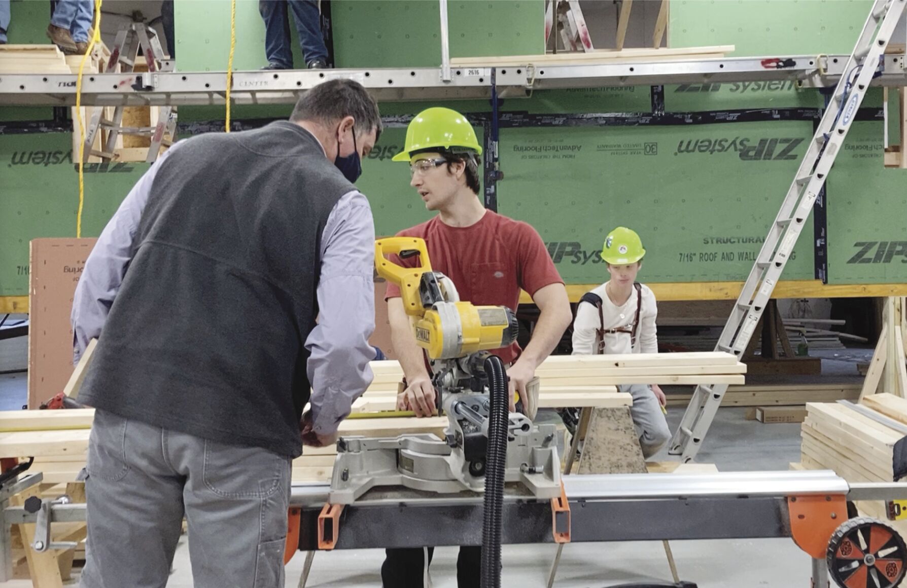 Builder helping students