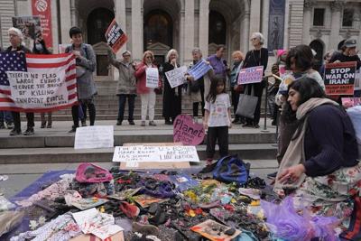 People protesting the U.S. and Israeli strikes on Iran gather in front of a New York Public Library location on March 8, 2026.