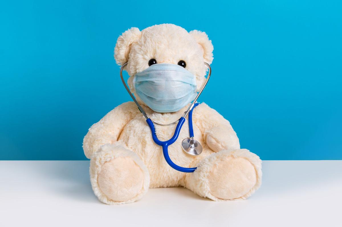 Teddy bear with protective medical mask and stethoscope. Concept of illness, hygiene and virus protection for children