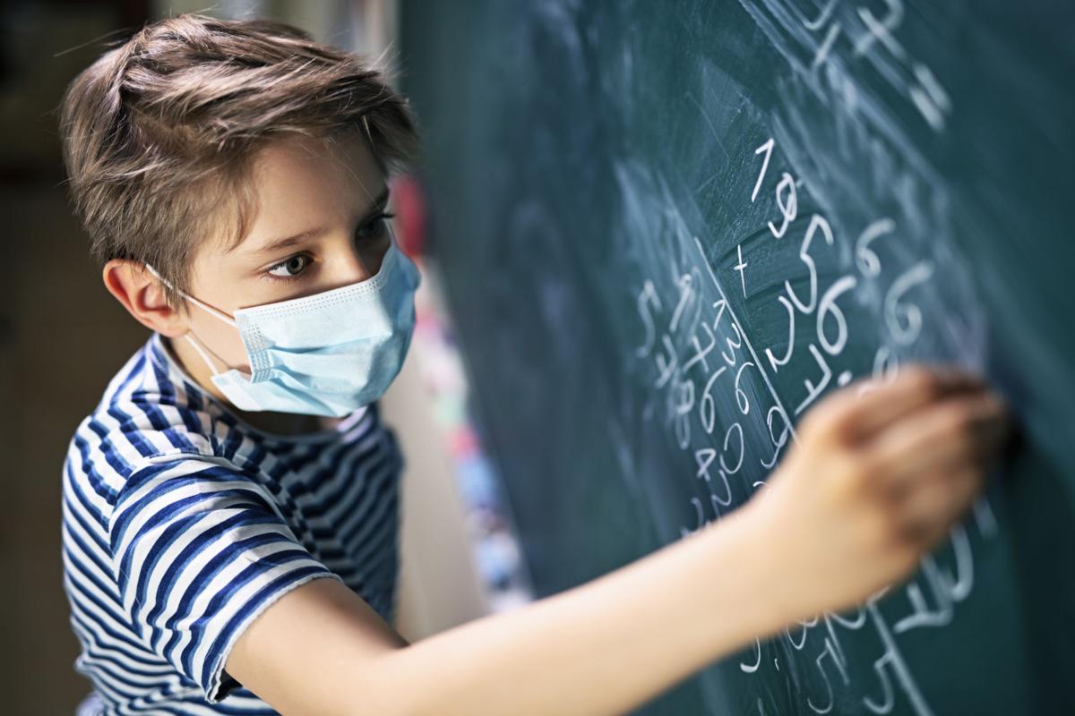 Cute little boy on math lesson during COVID-19 pandemic