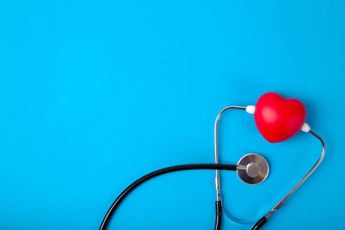 Top view world heart day stethoscope with 29 september text on blue paper background.Free copy space