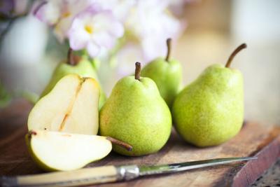 Fresh organic pears background. Ripe yellow large pears in wooden