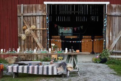Place setting on table against barn during party