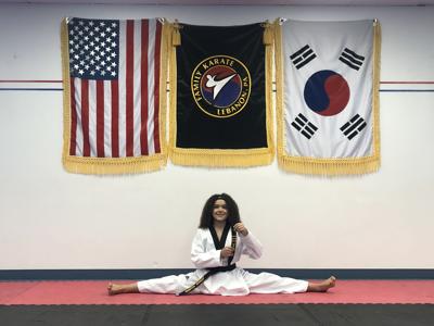 Joshua Aguirre poses with his third-degree black belt in taekwondo