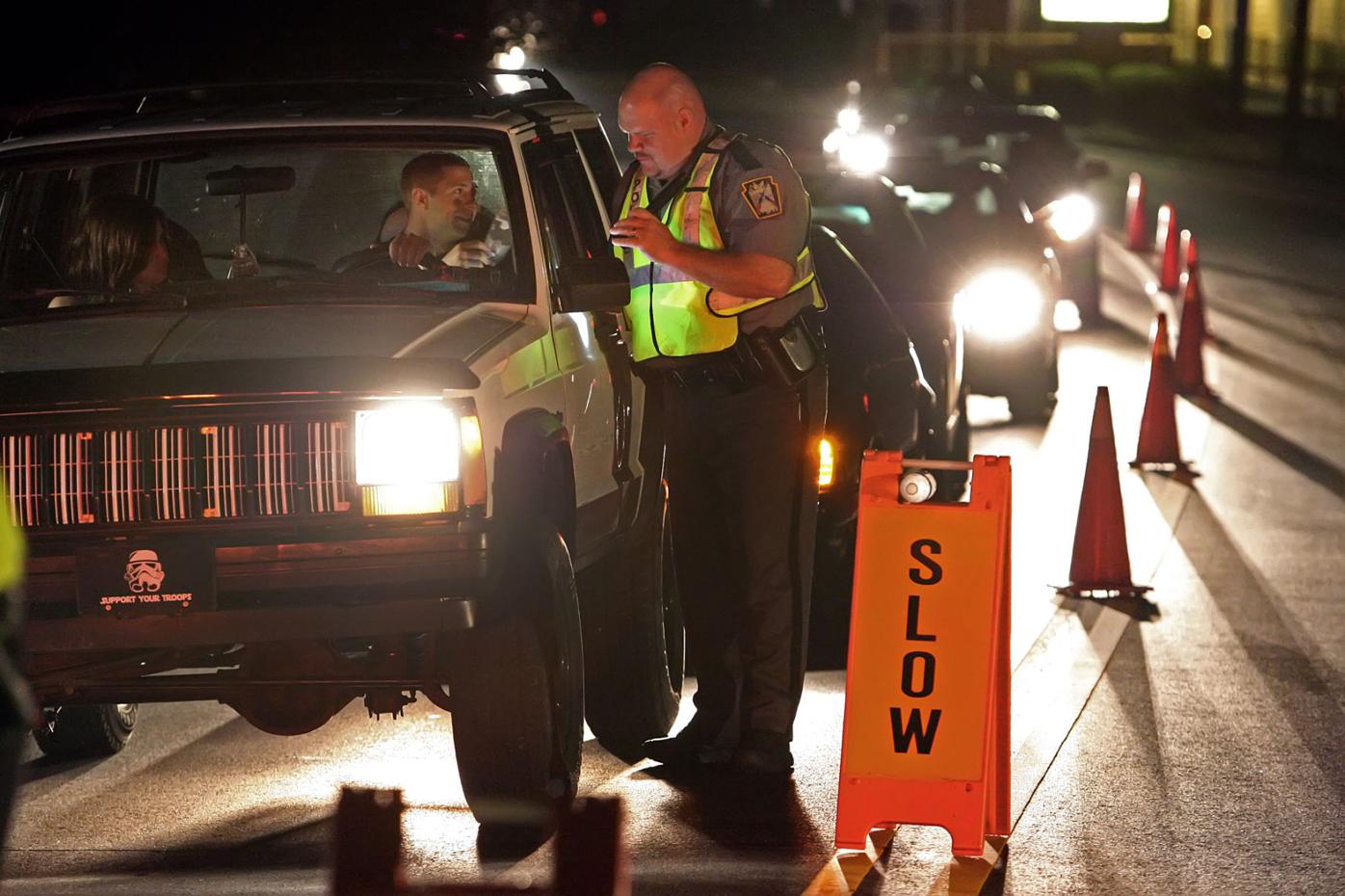 Looking for drunk drivers Police man sobriety checkpoint Local News