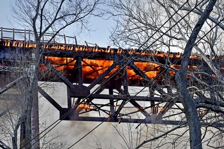 Deck of pedestrian bridge 'a loss' after fire strikes old railroad