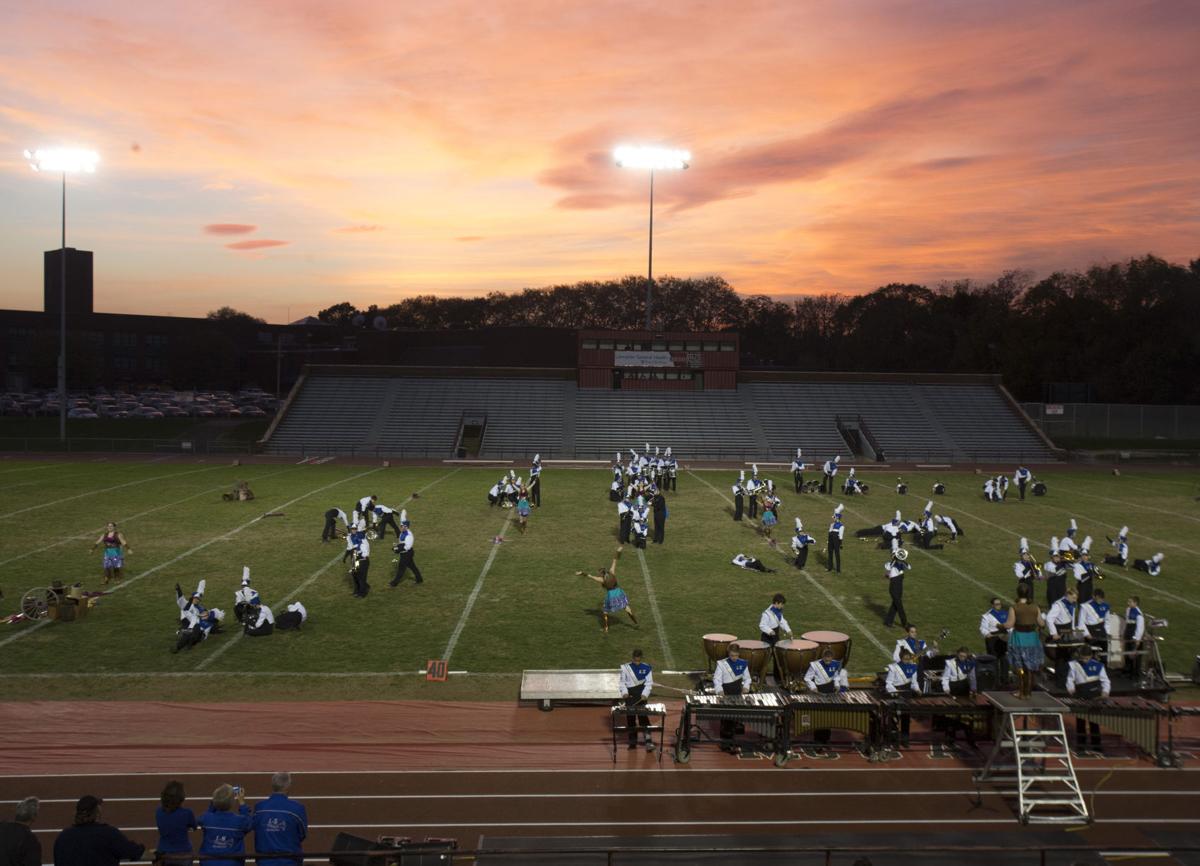Football parents and others in the stands under the Friday night lights
