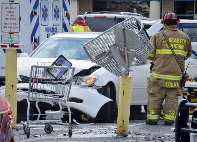 Car crashes into car, shopping cart and post in parking lot News