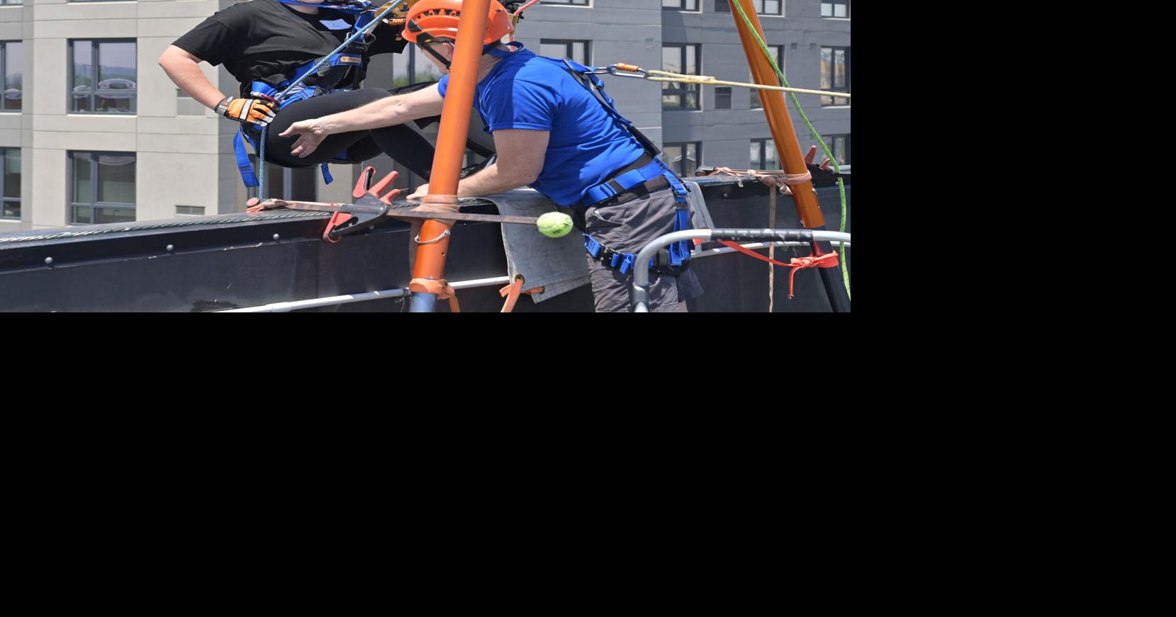 Reporter Alli Satterfield rappels at Eye Drop fundraiser for VisionCorps [photos]
