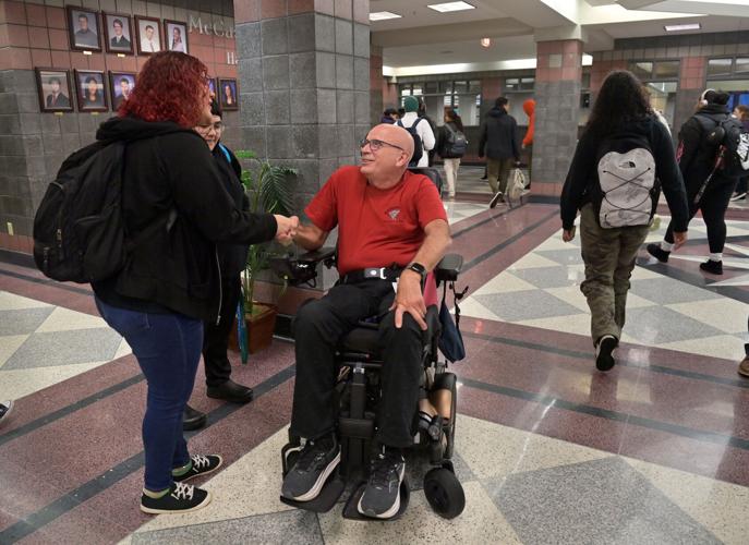 Brother Frank Albrecht greets students as they enter McCaskey East for