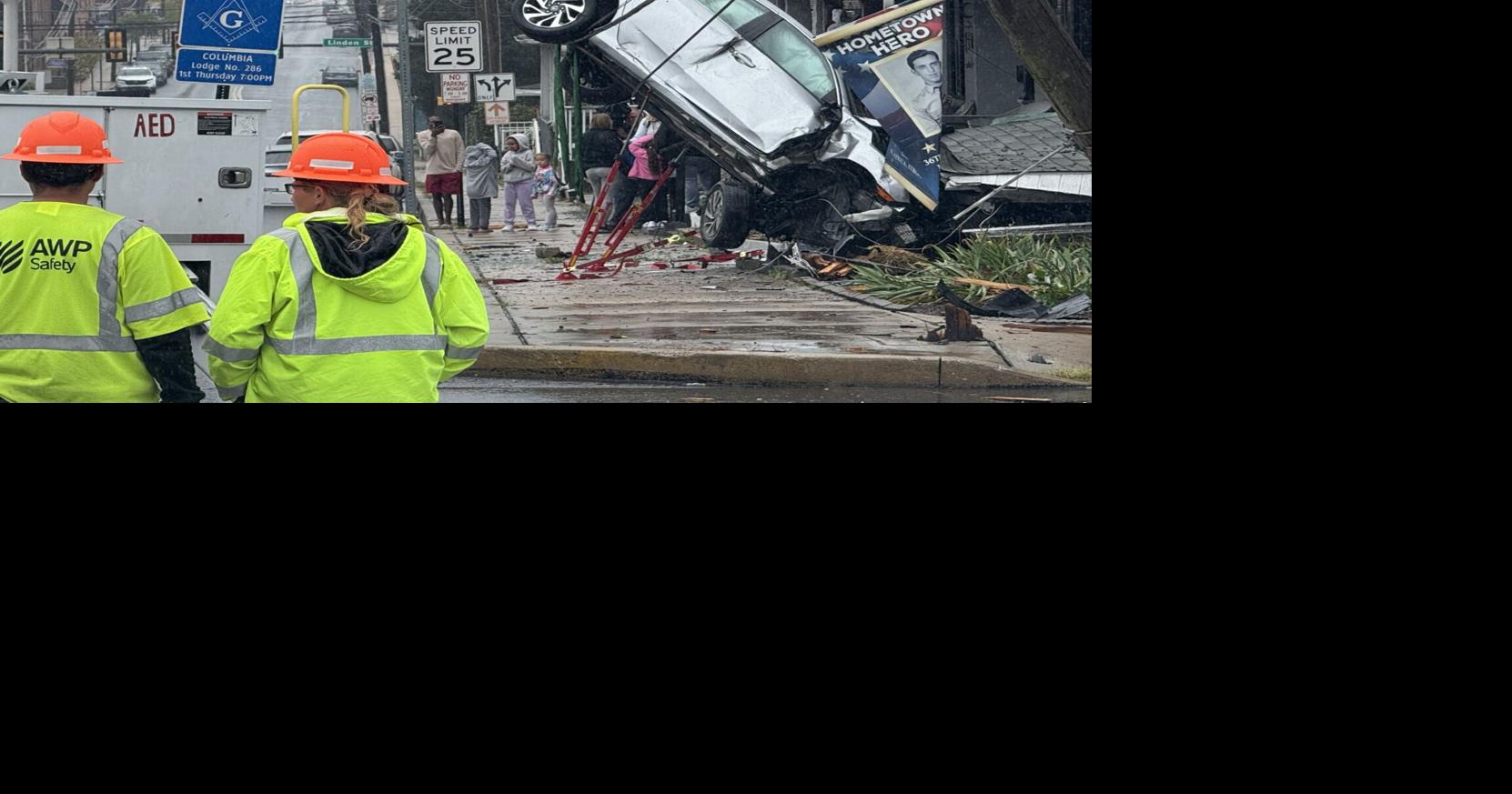 Motorist trapped after car goes airborne, crashes into porch of ...