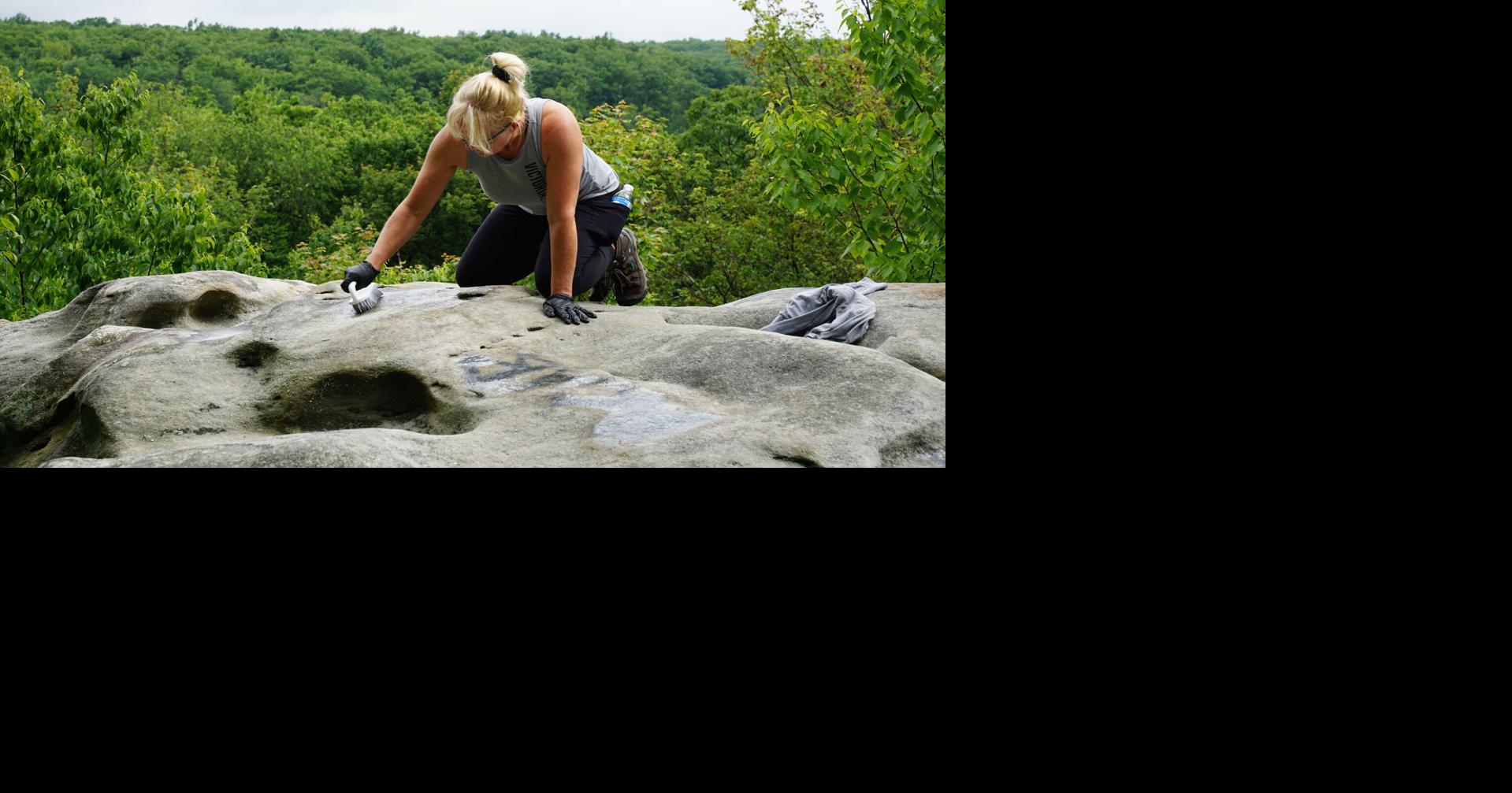 Volunteers help remove graffiti at Forbes State Park