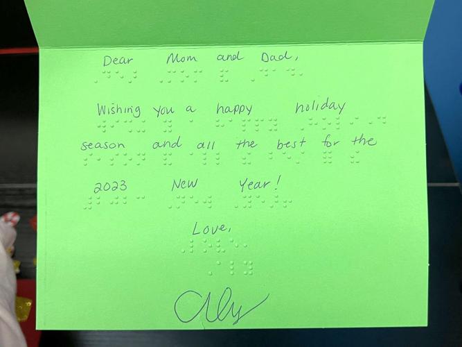 Student designing braille greeting cards for visually impaired Local