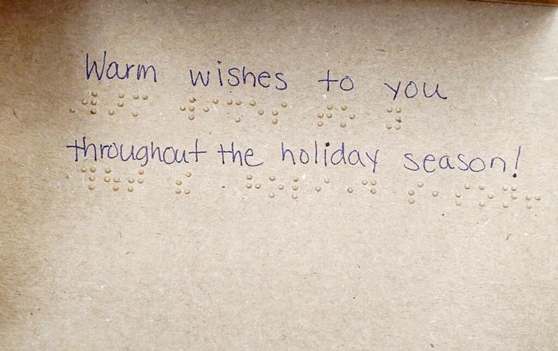 Student designing braille greeting cards for visually impaired Local