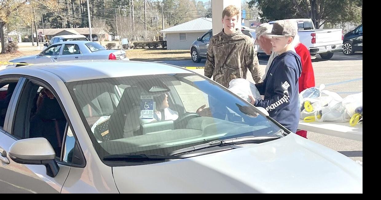 McDaniel boys lead the charge in annual turkey giveaway