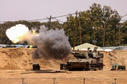An Israeli mobile artillery unit fires from a border position in southern Israel toward the Gaza Strip
