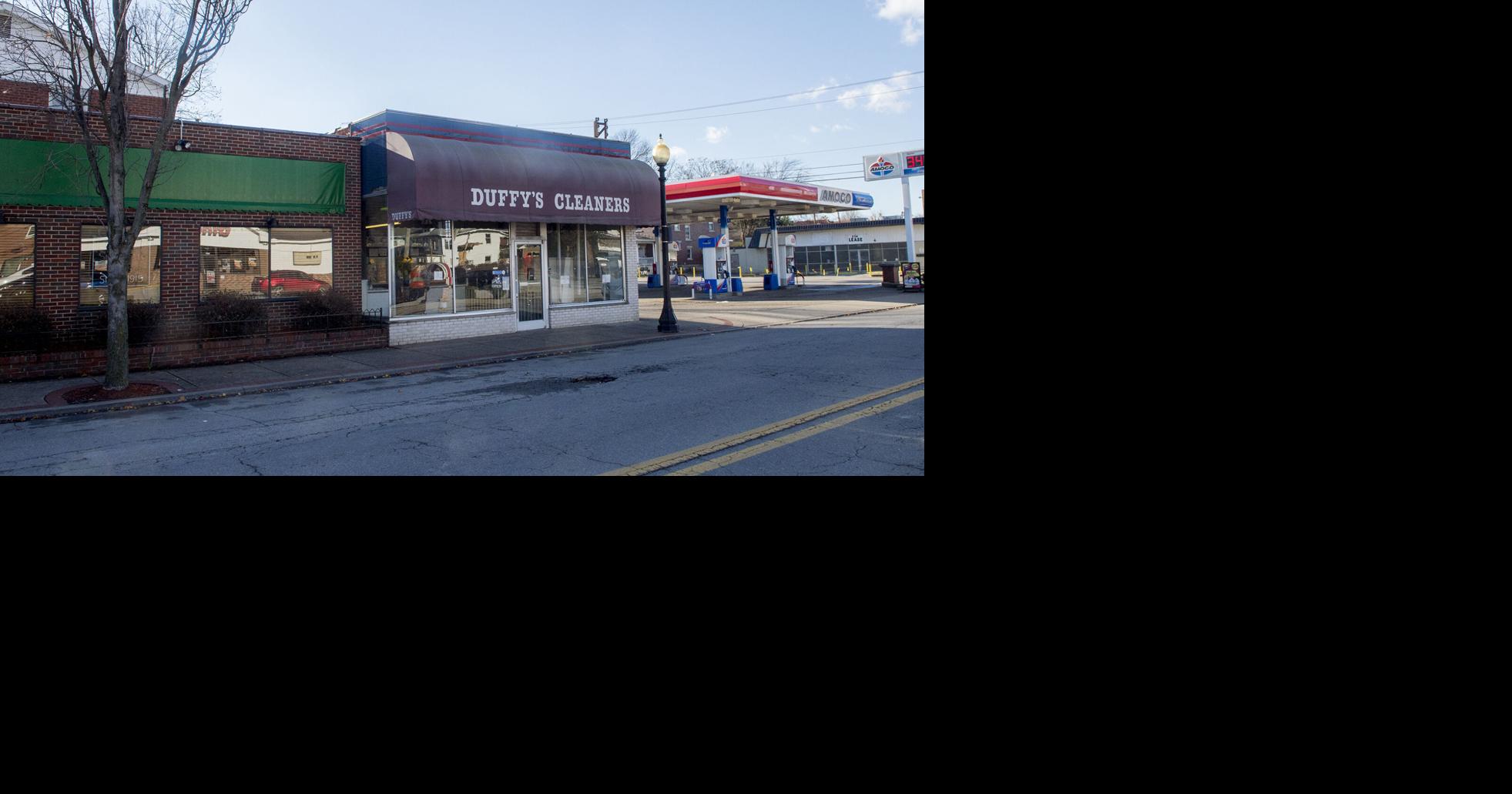 Employees working near temporarily shuttered convenience store express ...