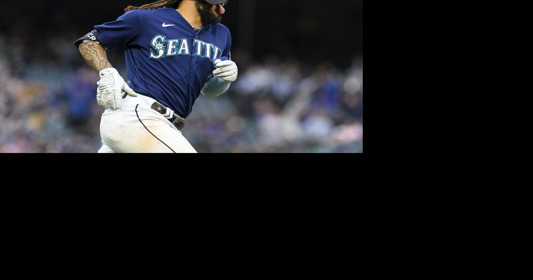 Seattle Mariners' J.P. Crawford (3) holds a trident after hitting