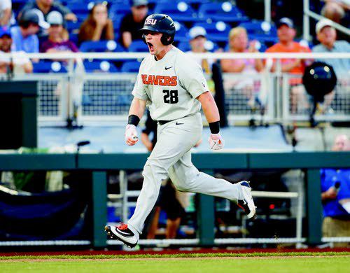 Oregon State's Steven Kwan, left and Adley Rutschman sit on top of