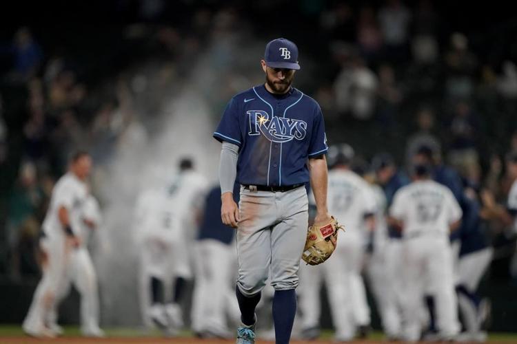 Tampa Bay Rays' Brett Phillips is greeted in the dugout after