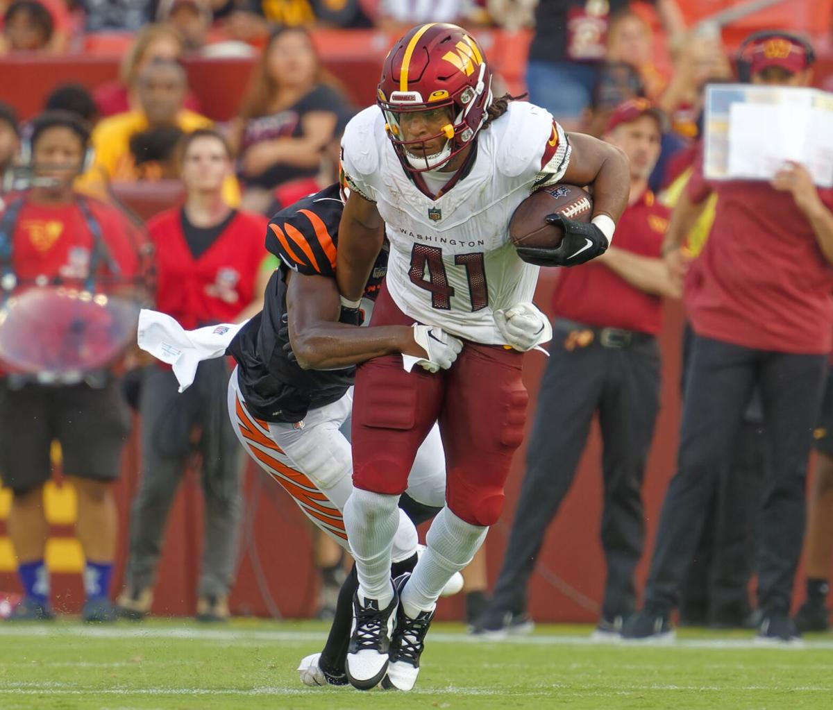 Washington Commanders wide receiver Mitchell Tinsley (86), left,  celebrating his touchdown against the Cincinnati Bengals with teammate  Marcus Kemp (19) and others during the first half of an NFL preseason  football game