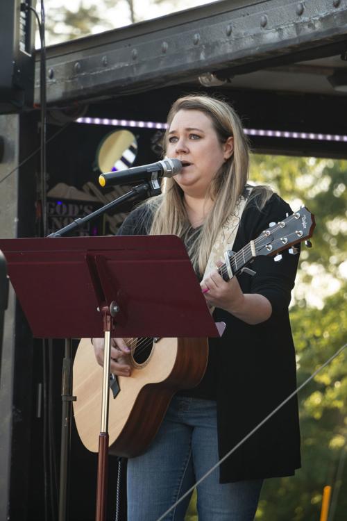 Sings songs of worship at community prayer service