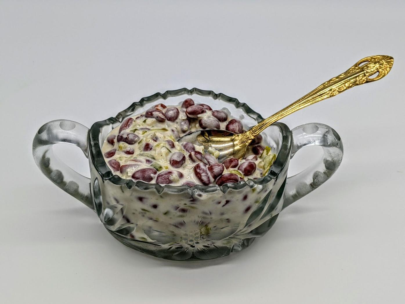 kidney bean salad in glass bowl with serving spoon