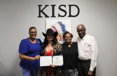 Karnack ISD presents high school diploma to 1993 graduate Rhonda Mayfield Rivas