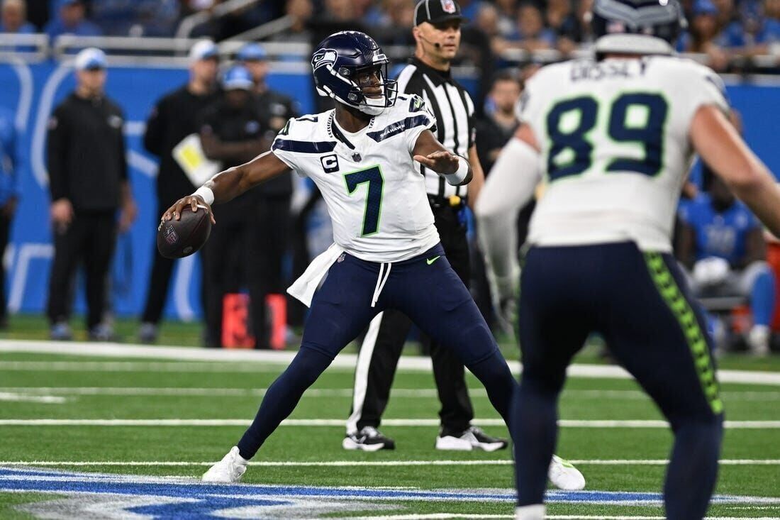 Seattle Seahawks quarterback Geno Smith lofts 23-yard pass to wide