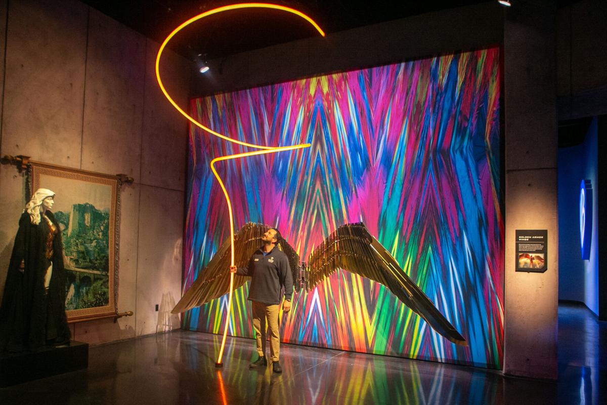 Tour guide John Kourounis lights up Wonder Woman’ s Lasso of Truth, one of the new interactive exhibits that will be available to visitors who go on the Warner Bros.