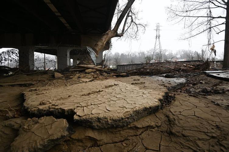 Debris and mud-covered chunks of concrete beneath the Hendersonville Road Bridge in Asheville seen Sunday, Dec. 15, 2024, nearly three months after Tropical Storm Helene hit the region.