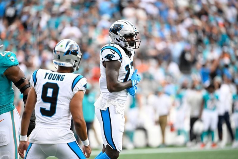 Oct 5, 2025; Charlotte, North Carolina, USA; Carolina Panthers wide receiver Xavier Legette (17) reacts after catching a touchdown pass from quarterback Bryce Young (9) in the second quarter at Bank of America Stadium. Mandatory Credit: Bob Donnan-Imagn...