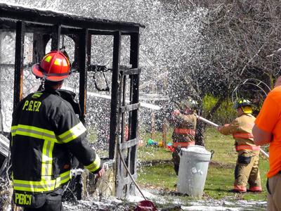 IMAGE: Shed fire threatens home, no injuries