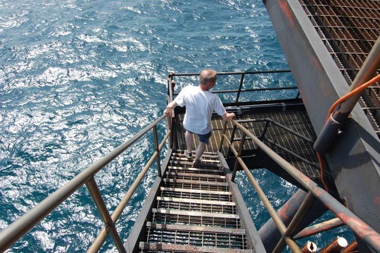 Frank Bellamy explores underneath Frying Pan Tower. The structure opened in 1964 as a Coast Guard light tower to guide boats away from the shallows of Frying Pan Shoals.