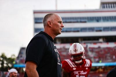 Aug 28, 2025; Raleigh, North Carolina, USA; North Carolina State Wolfpack head coach Dave Doeren looks on during the warmups prior to the game against East Carolina Pirates at Carter-Finley Stadium. Mandatory Credit: Jaylynn Nash-Imagn Images