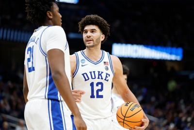 Mar 29, 2026; Washington, DC, USA; Duke Blue Devils forward Cameron Boozer (12) talks to Blue Devils center Patrick Ngongba (21) during a stoppage in play against the UConn Huskies in the second half during an Elite Eight game of the East Regional of th...