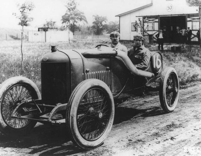 RENE THOMAS (behind steering wheel) and ROBERT LALY(riding mechanic) in the #16 Delage car. The unidentifed man in background is believed to be the team manager. Thomas won the May 30, 1914 Indianpolis 500 Mile race with an average speed of 82.474 mph. ...