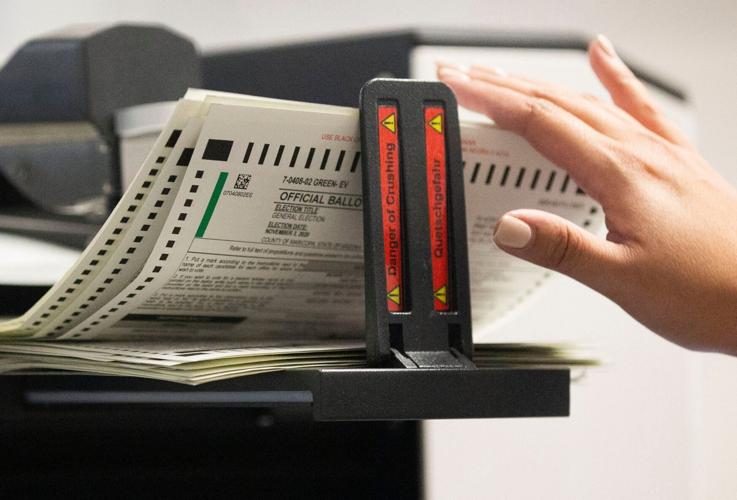 Mail-in ballots are tabulated at the Maricopa County Elections Headquarters in Phoenix on Oct. 20, 2020.