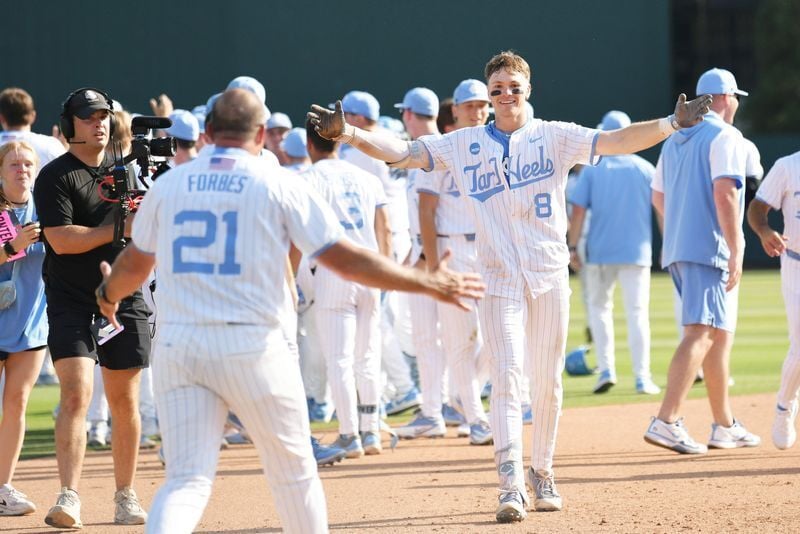 June 7, 2026; Chapel Hill, NC, USA; North Carolina Tar Heels outfielder Owen Hull (8) celebrates with head coach Scott Forbes after his game winning hit against the USC Trojans at Boshamer Stadium. Mandatory Credit: Zachary Taft-Imagn Images