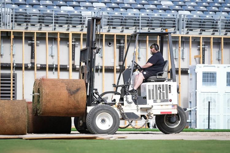 A worker transports sod
