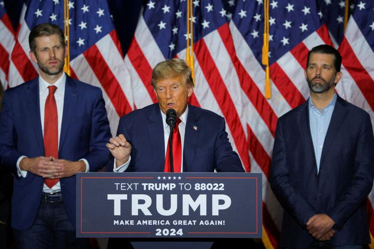 FILE PHOTO: Donald Trump appears with his sons Eric Trump and Donald Trump Jr. in Iowa in 2024