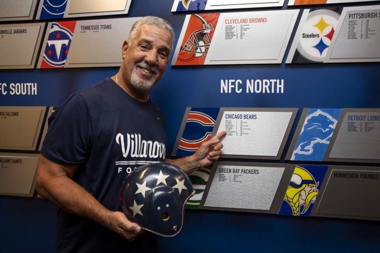 Villanova head football coach Mark Ferrante posed for a portrait with an all-star helmet worn by former fullback Ralph Pasquariello, who played in the 1950 Chicago Charities game, with the team that defeated the Eagles.