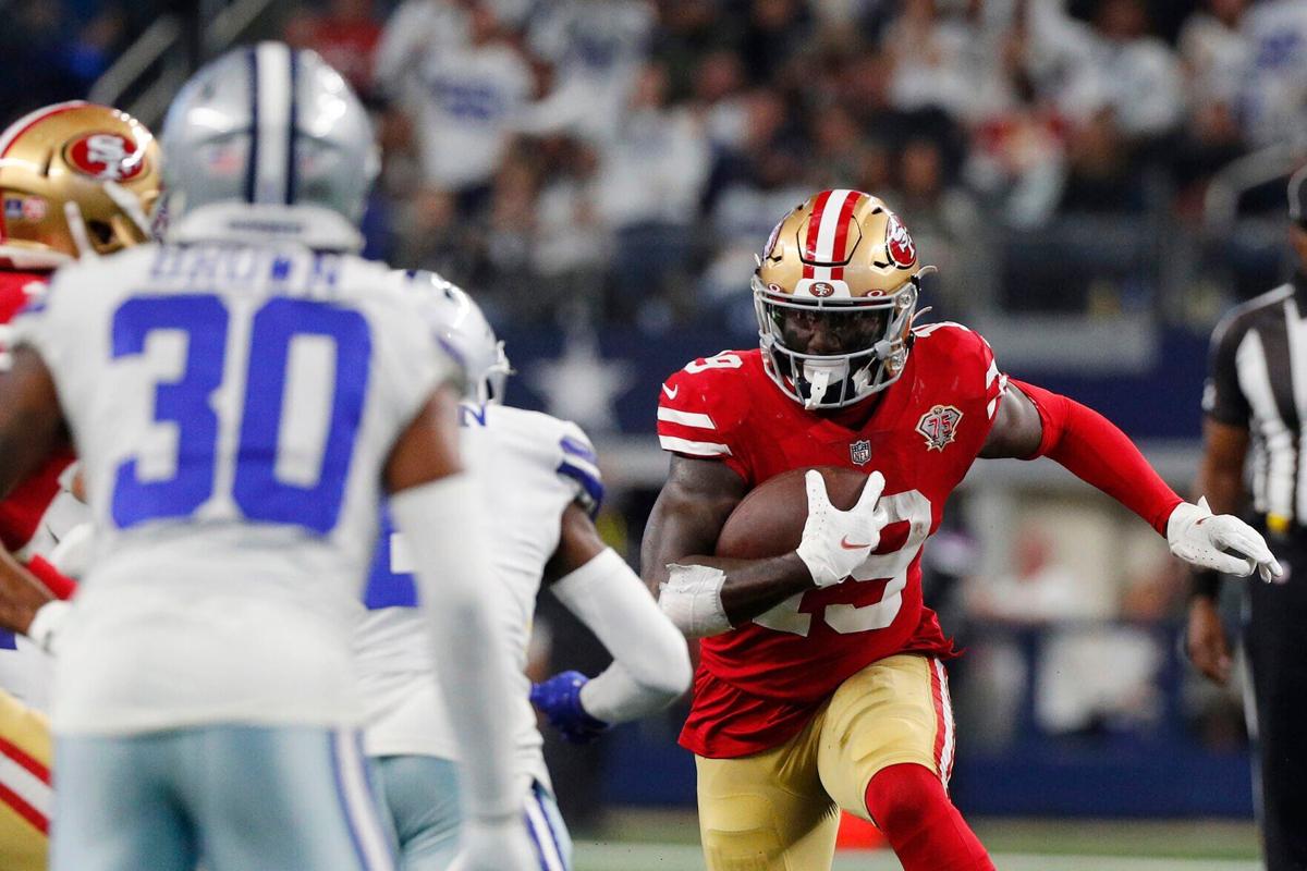 Deebo Samuel of the San Francisco 49 ers carries the ball after a reception against the Dallas Cowboys during the second quarter in the NFC Wild Card Playoff game at AT&T Stadium on January 16, 2022, in Arlington, Texas.
