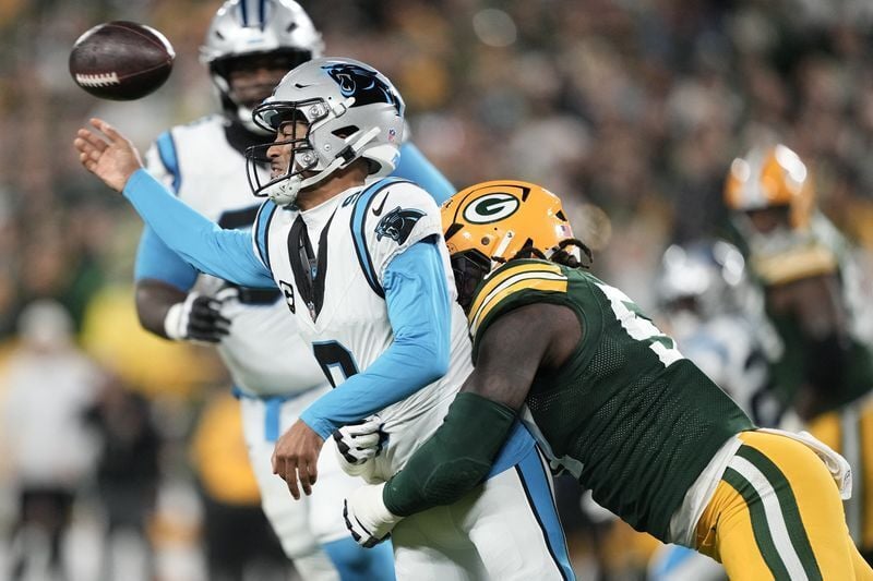 Oct 29, 2026; Green Bay, Wisconsin, USA;  Green Bay Packers defensive end Brenton Cox Jr. (57) pressures  Carolina Panthers quarterback Bryce Young (9) in the first half at Lambeau Field.  Mandatory Credit: Jeff Hanisch-Imagn Images