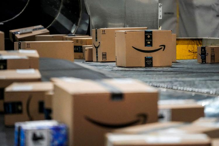 FILE PHOTO: An Amazon box moves along a conveyor belt at Amazon’s fulfillment center in New Jersey