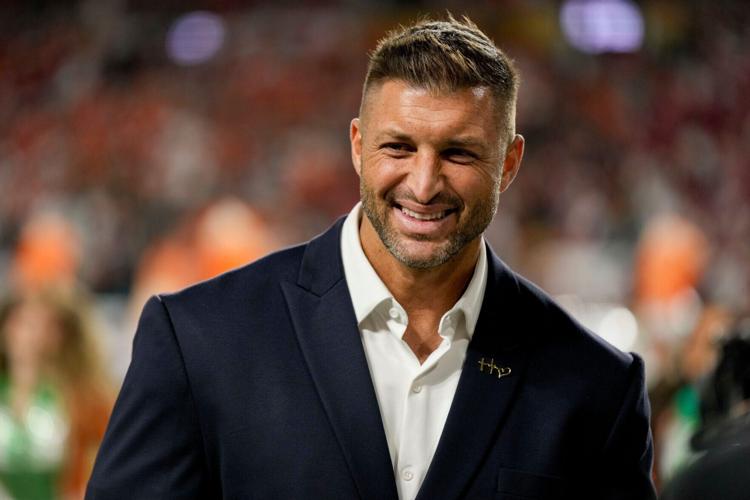 Tim Tebow stands on the sidelines Monday, Jan. 19, 2026, ahead of the College Football Playoff National Championship college football game between the Indiana Hoosiers and the Miami (FL) Hurricanes at Hard Rock Stadium in Miami Gardens.
