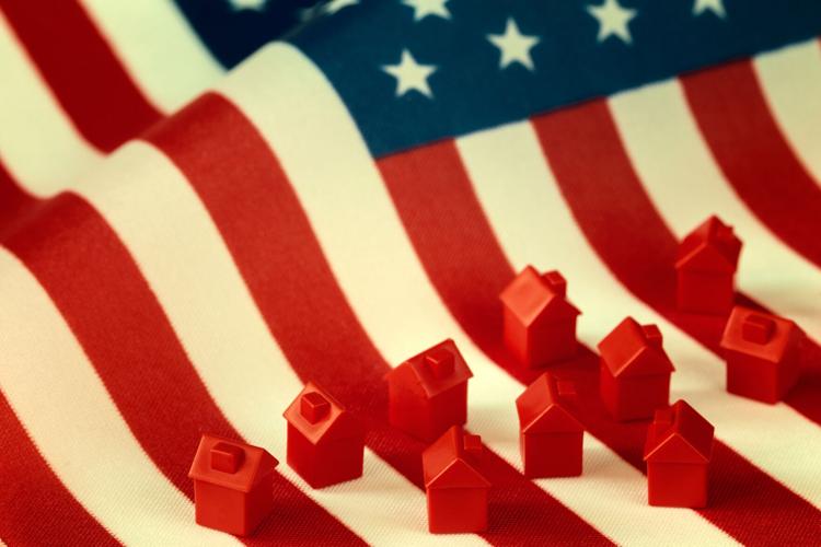 Mini houses against USA flag background