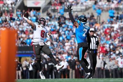 Oct 25, 2026; Charlotte, North Carolina, USA;  Tampa Bay Buccaneers quarterback Baker Mayfield (6) makes a pass for a touchdown against Carolina Panthers safety Tre'von Moehrig (7) during the second half at Bank of America Stadium.  Mandatory Credit: Bo...
