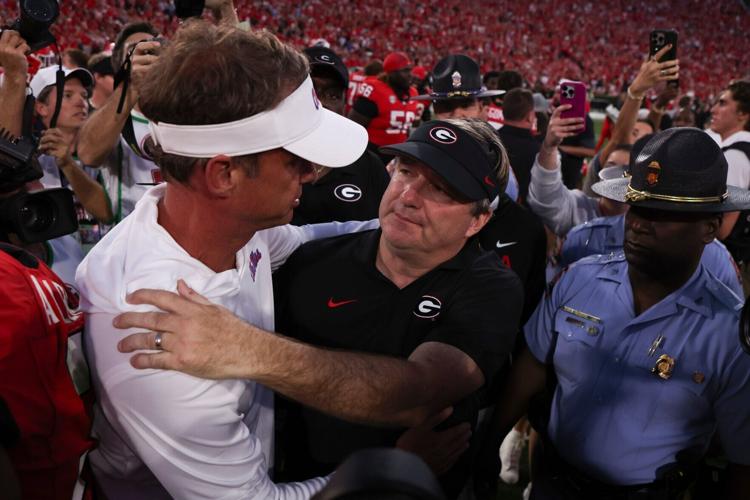 Oct 18, 2025; Athens, Georgia, USA; Georgia Bulldogs head coach Kirby Smart and Mississippi Rebels head coach Lane Kiffin meet on the field after the game at Sanford Stadium. Mandatory Credit: Brett Davis-Imagn Images